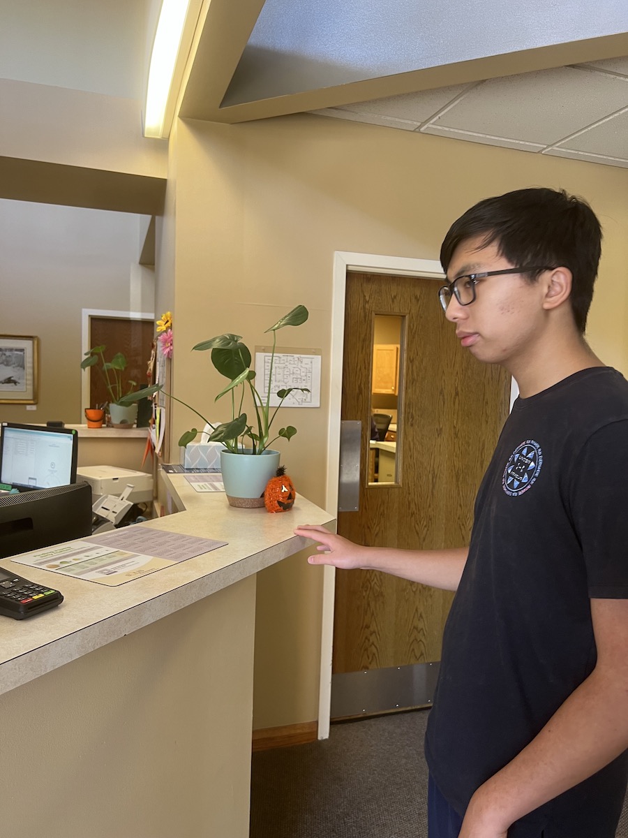 A young Asian man checking in at the doctor’s office.