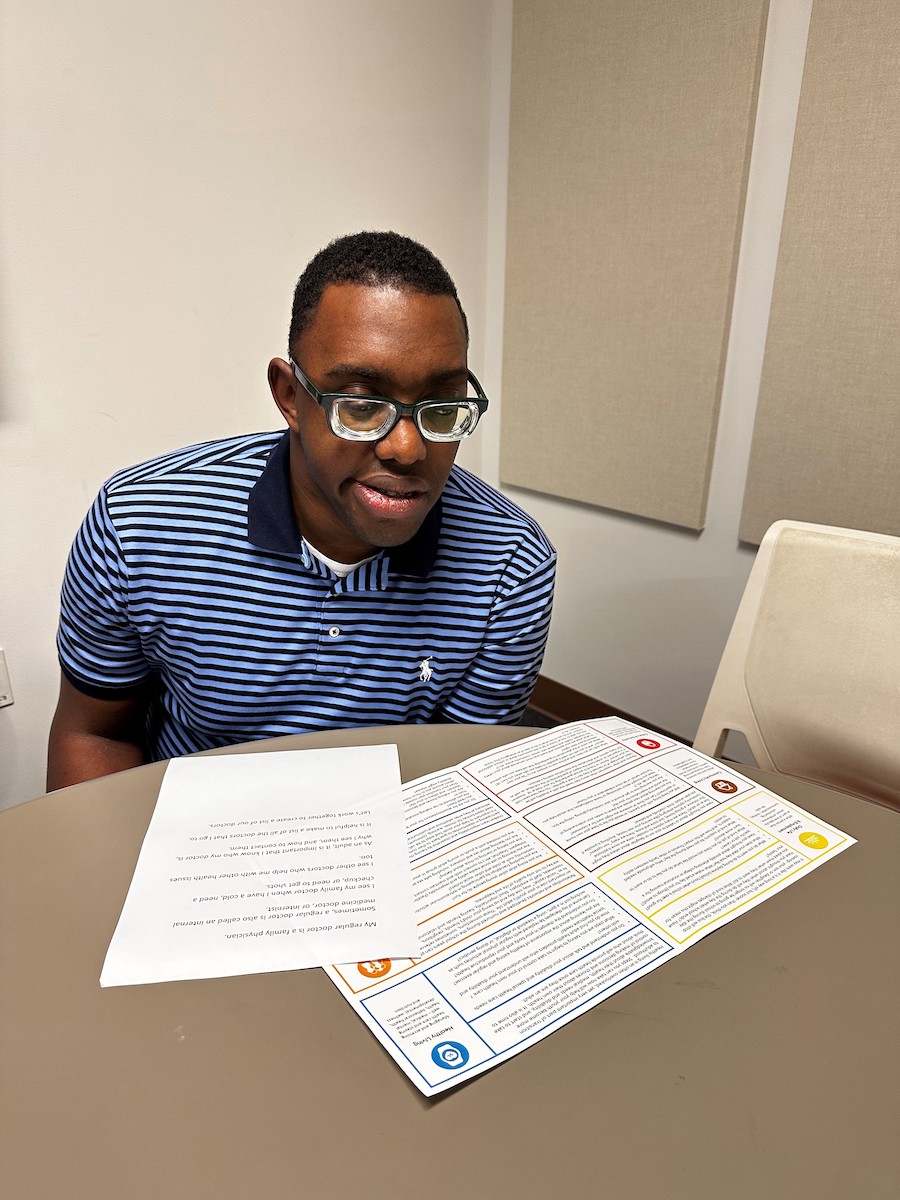 Young man seating while reading documents.