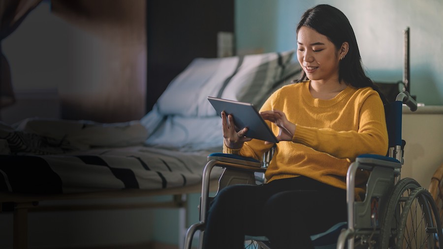 Young woman in a wheelchair smiling.