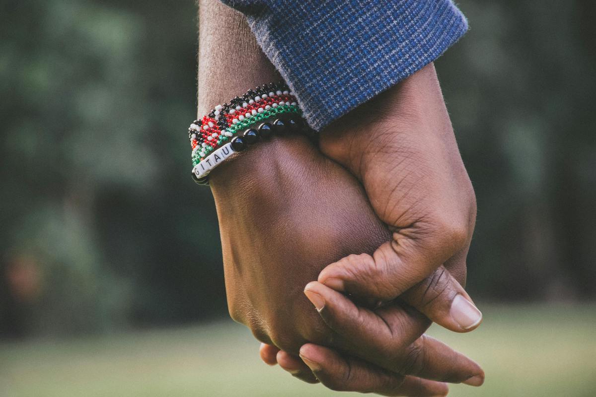 A picture of two hands holding each other.